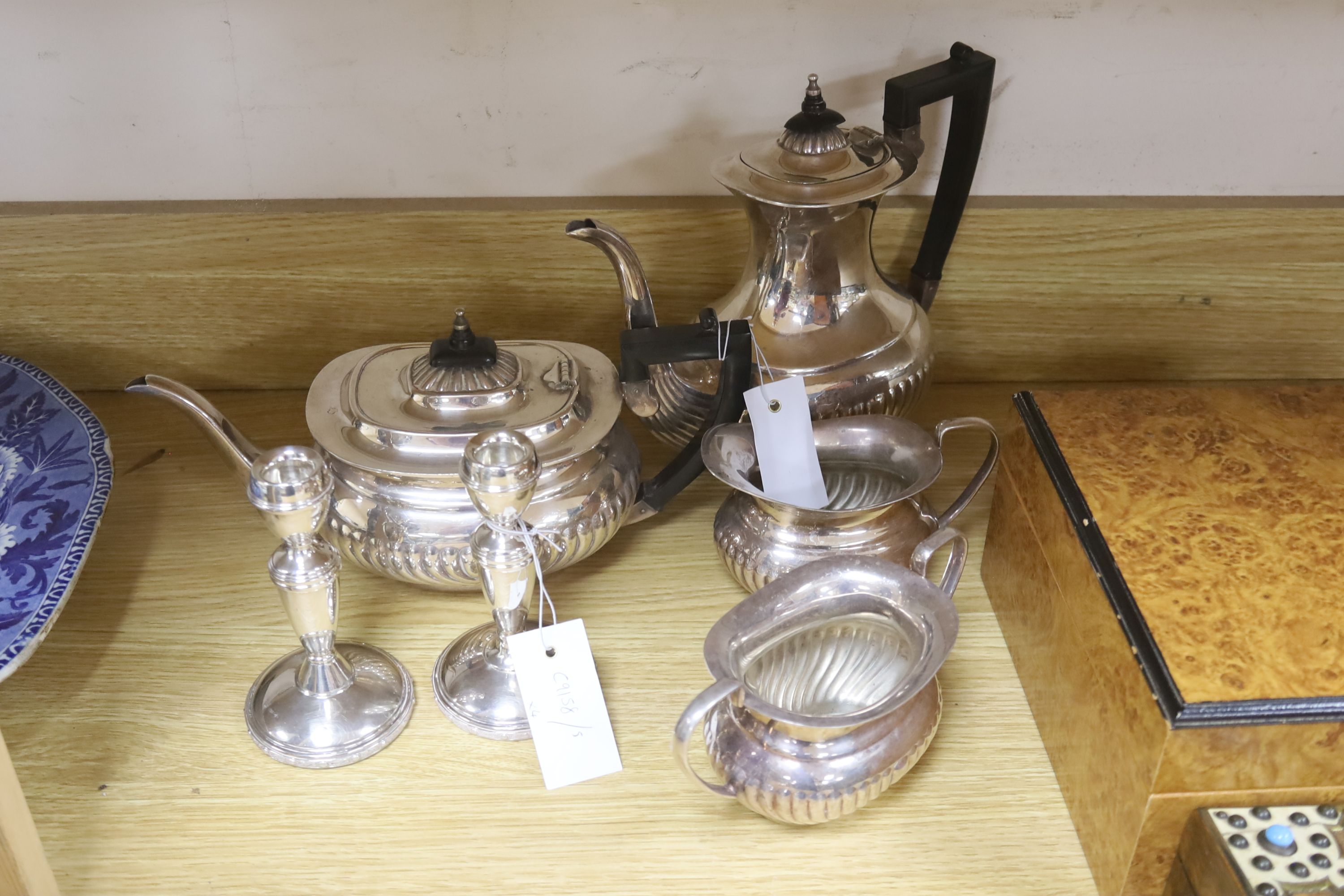 A Victorian studded box, a modern humidor, two candlesticks and a four piece silver plated tea set